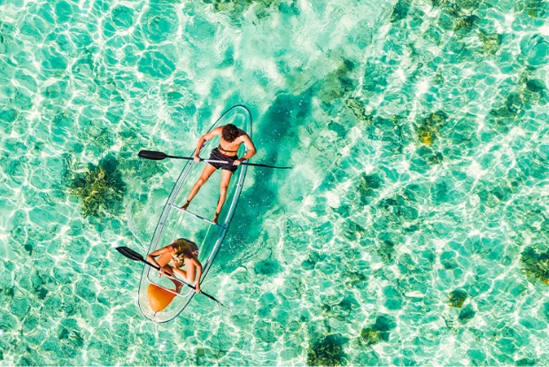 couple in clear boat on water